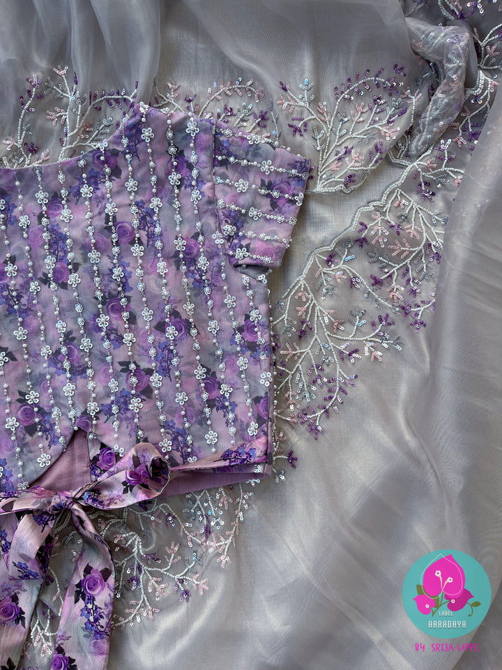 Soft tissue grey saree with embroidered sequins work Paired with Floral silk with embroidered net